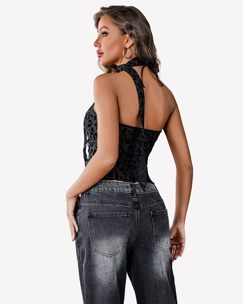 Black mesh Y2K crop top with leopard print, halter neck, and black jeans, casual wear