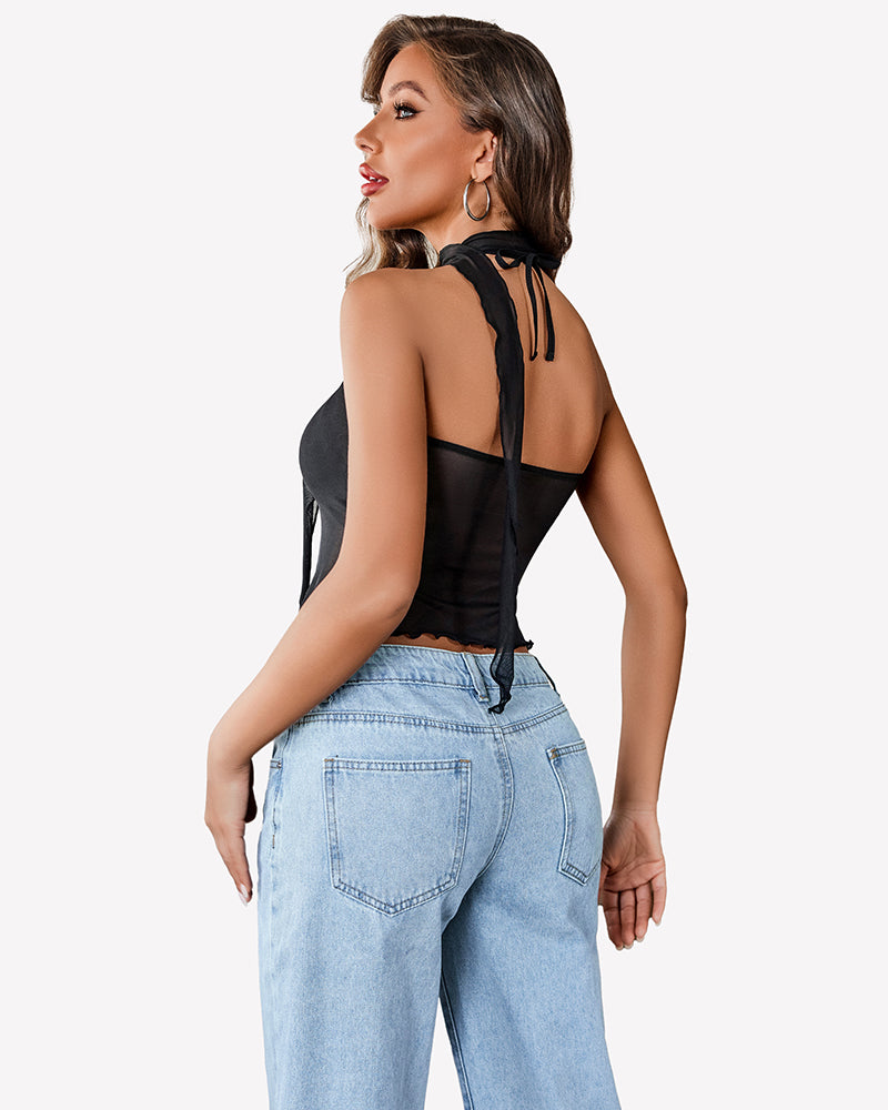 Black mesh Y2K crop top with halter neck and tie detail, paired with light-wash jeans, casual wear