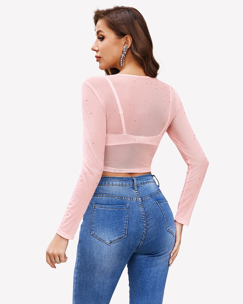 Pink rhinestone mesh see through crop top with long sleeves and blue jeans. Sexy lingerie.