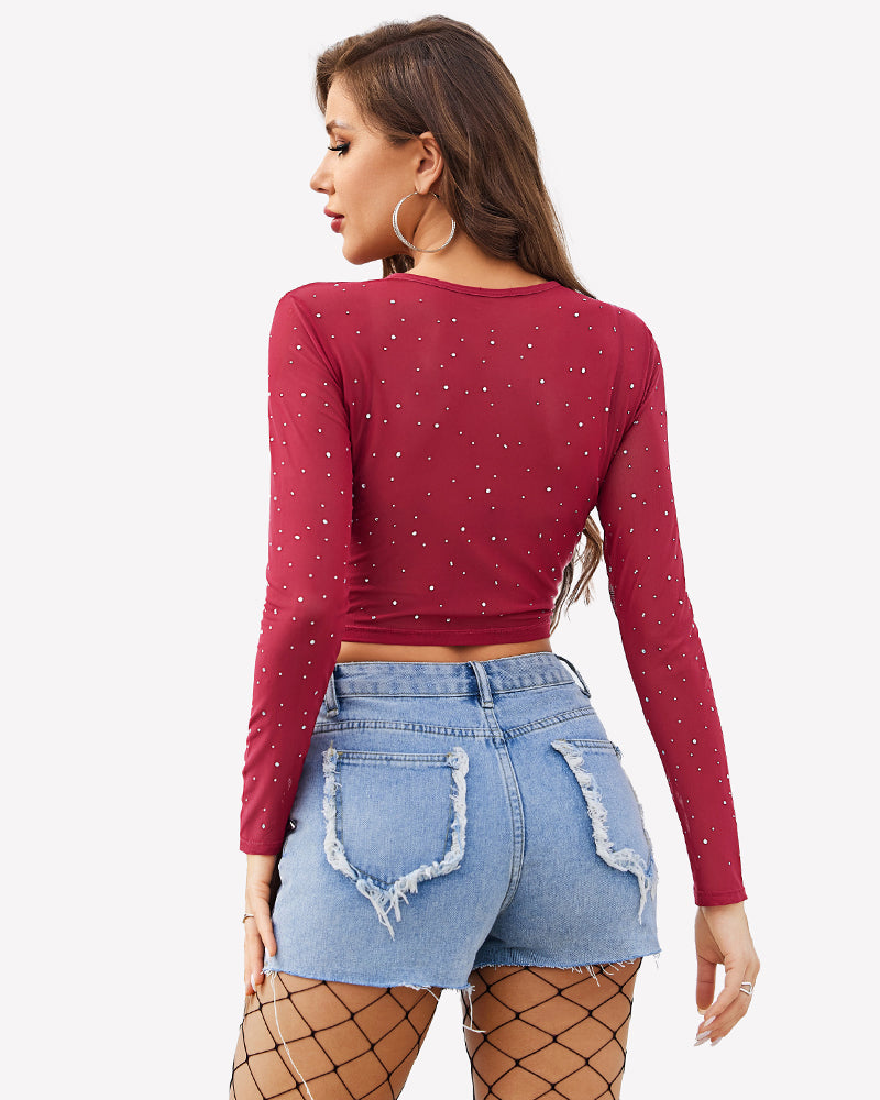 Burgundy rhinestone mesh crop top with long sleeves and blue denim shorts. Sexy lingerie.
