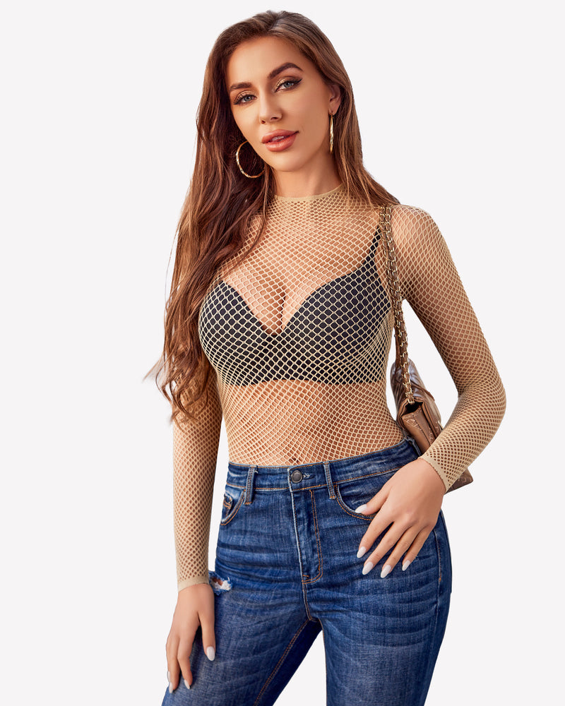 Beige fishnet mesh long sleeve top, black bra, and blue jeans. Sheer party top.