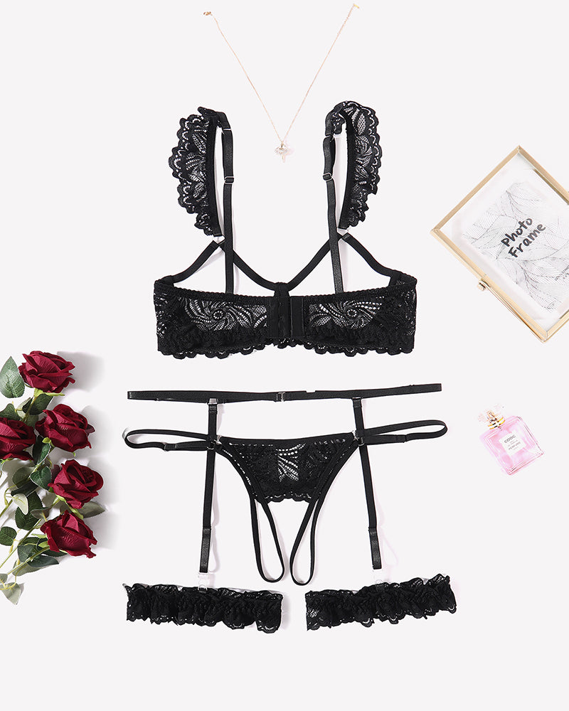 Black lace lingerie set: bra, garter belt, thong, and leg rings. Romantic nightwear.