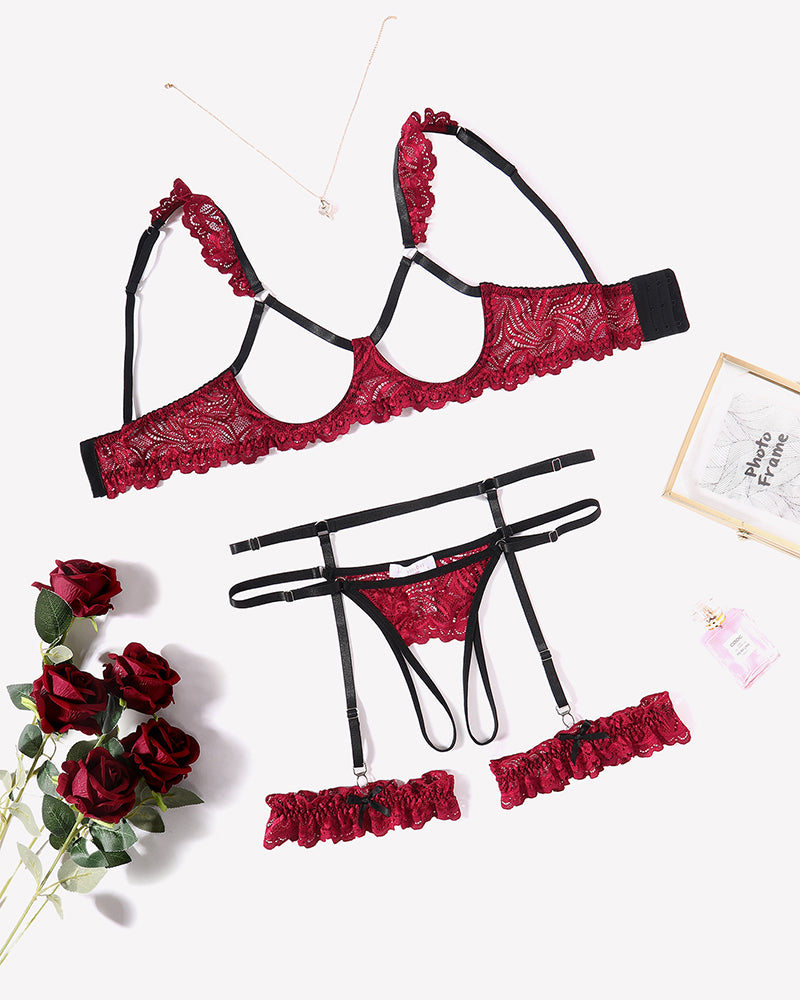 Red floral lace lingerie set with garter belt, bra, and panty, perfect for a romantic night.