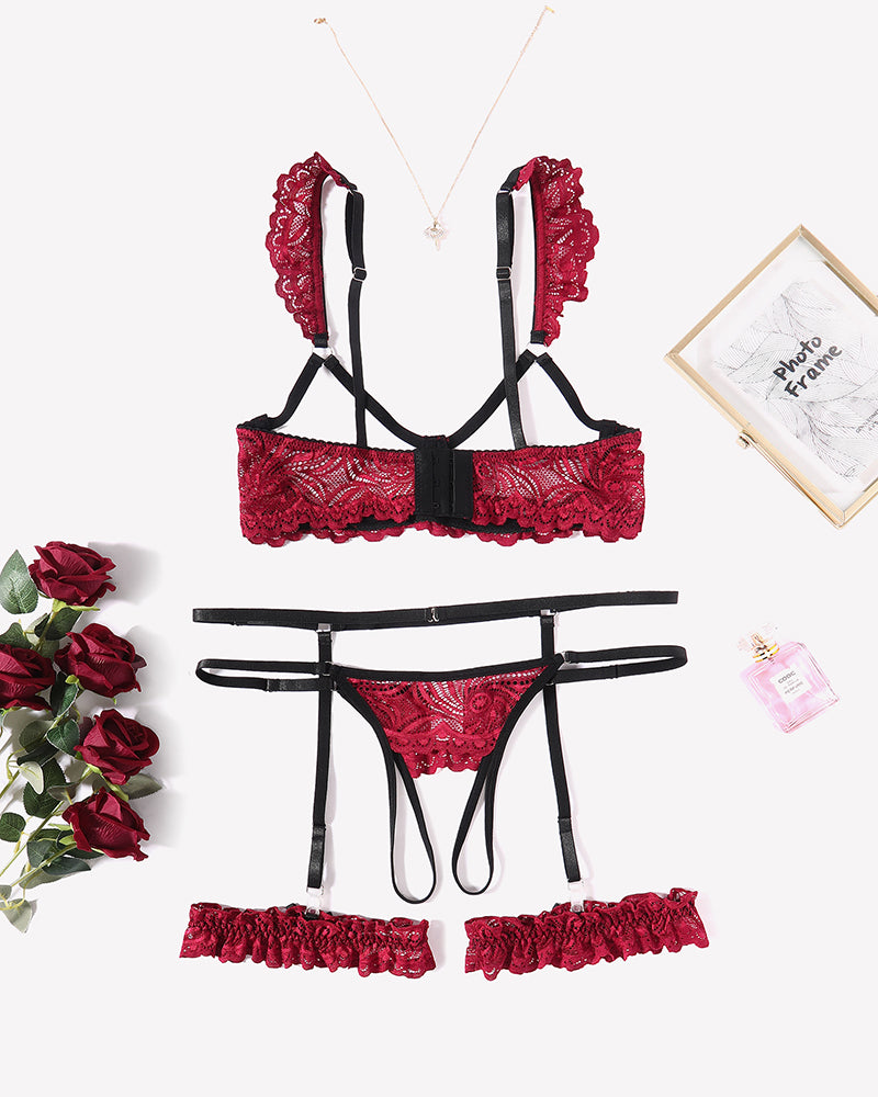 Red floral lace lingerie set with garter belt, bra, thong, and leg rings. Romantic nightwear.
