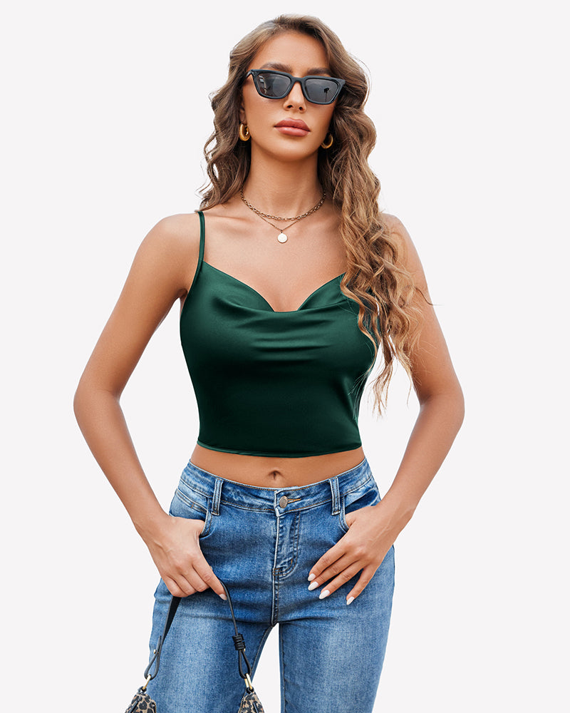 Green silk satin camisole Y2k tank top with spaghetti straps and blue jeans. Stylish.