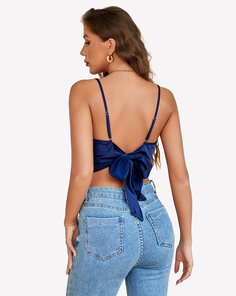 Navy blue satin camisole Y2k tank top with bow tie back, blue jeans. Modern and stylish.