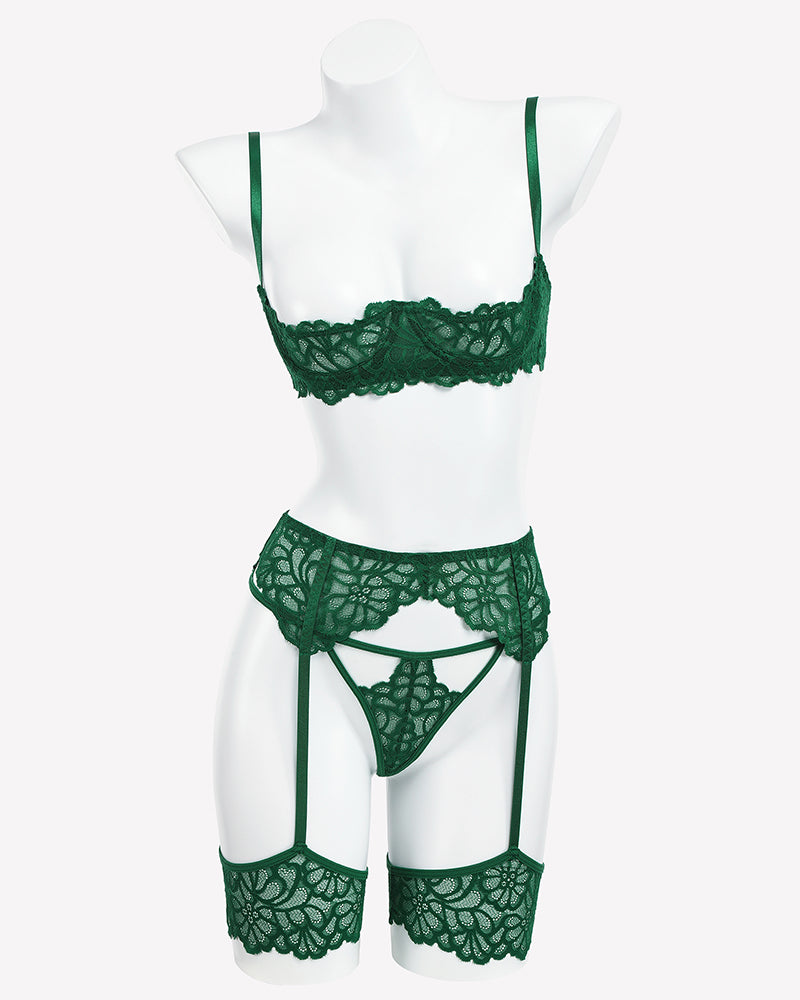 Green lace lingerie set with bra, lace thong, and garter belt on mannequin