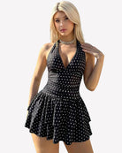 Black polka dot V-neck ruched mini dress with tiered ruffle hem