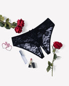 Black floral lace boyshort panties with hollow-out center and bow at waistband.
