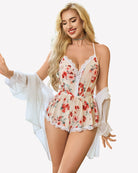 Floral cami romper with lace trim and spaghetti straps, red blooms on light base