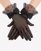 Black mesh short gloves with polka-dot accents and oversized bow ties at wrist