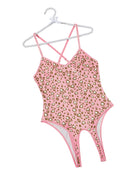Pink leopard print teddy bodysuit with crisscross straps and thong-style back.