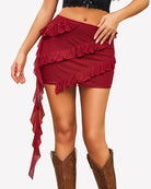 Wine red asymmetrical ruffle tie mini skirt with layered frill trim and side drape tie