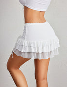 White high waist ruffle mini skort with layered skirt tiers and side drawstring ties