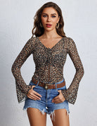 Leopard print crop top modeled with a V-neck, ruched tie front, and bell sleeves