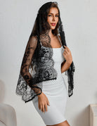 Black lace mantilla veil with scalloped edge, side drape over shoulders