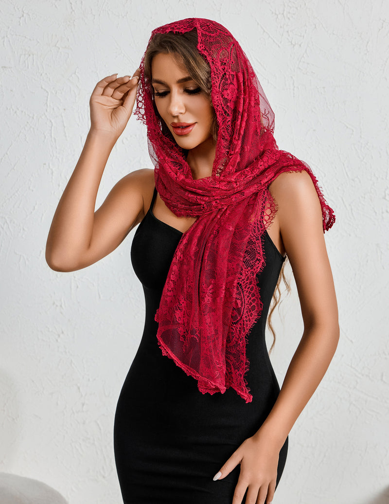 Dark red lace mantilla veil with scalloped edge, wrapped around neck and shoulders