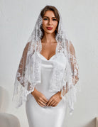 White lace mantilla veil with scalloped edge and floral lace trim.