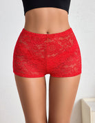 Sheer lace micro shorts, vivid red floral lace, low-rise elastic waistband.