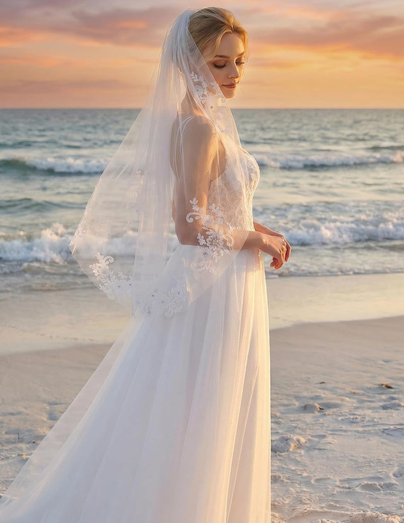 White fingertip-length bridal veil with scalloped lace edge and comb