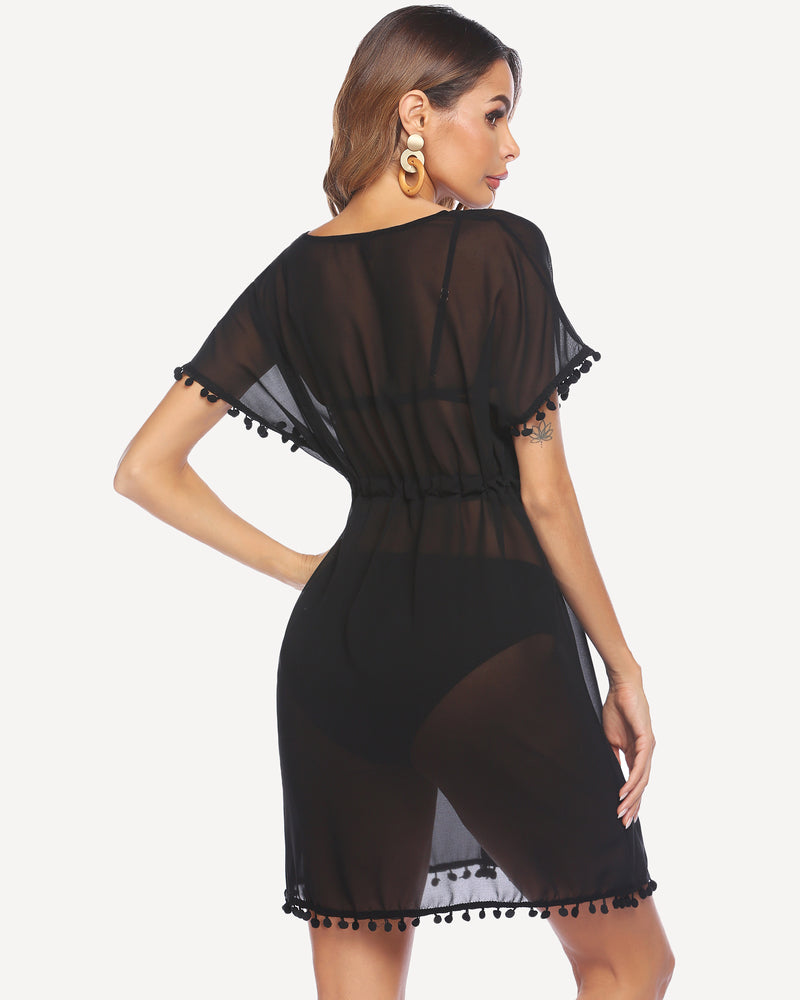 Black sheer swimsuit cover-up with tassels and drawstring waist, perfect for the beach or pool.