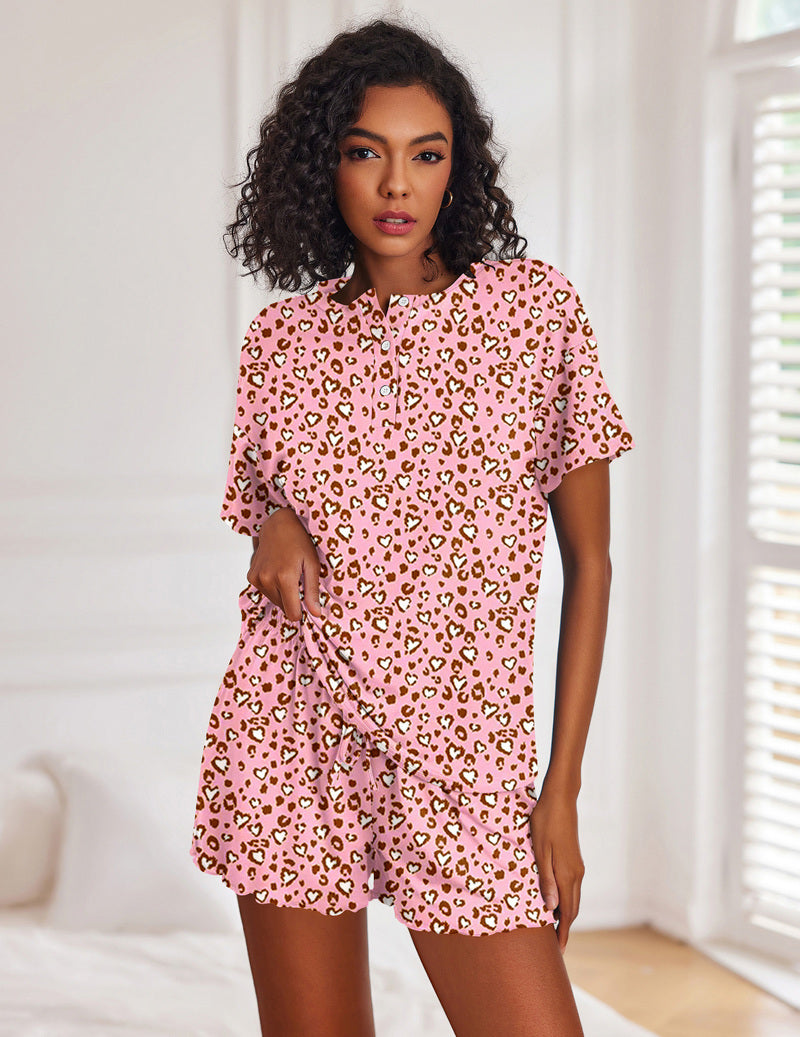 Pink leopard print short-sleeve pajama set with button-front top and matching drawstring shorts