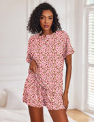 Pink leopard print short-sleeve pajama set with button-front top and matching drawstring shorts