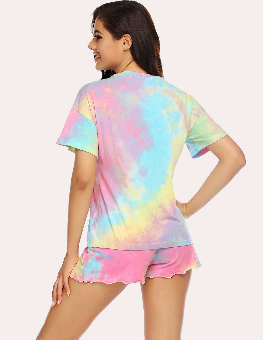 Tie-dye pajama set back view: short-sleeve button top and ruffled shorts, pastel