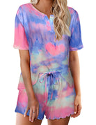 Women’s tie-dye pajama set in pastel blue and pink; short-sleeve button top with drawstring elastic waist shorts