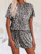 Gray leopard print short-sleeve pajama set with snap-button top and elastic waist shorts