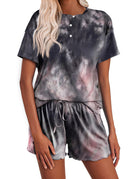 Women’s tie-dye pajama set in dark gray with subtle green and purple; button short-sleeve top, drawstring shorts