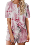 Women’s tie-dye pajama set in pale pink with darker pink clouds; short-sleeve button top and drawstring shorts