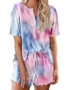 Women’s tie-dye pajama set in purple, blue, and pink; short-sleeve button top with drawstring shorts