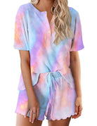Pastel tie-dye pajama set for women: short-sleeve henley top and drawstring shorts.
