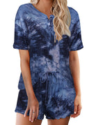 Women’s tie-dye pajama set in deep blue; short-sleeve button henley top with matching drawstring shorts
