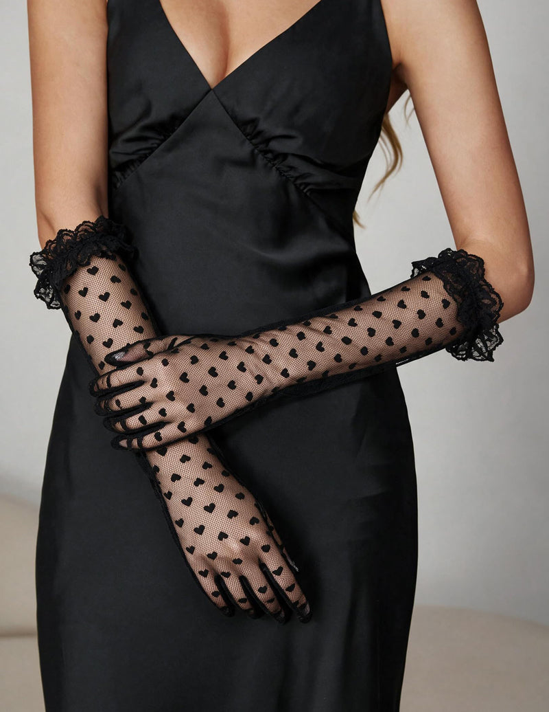 Black sheer heart-print gloves, shown with lace-trimmed ruffle wrists