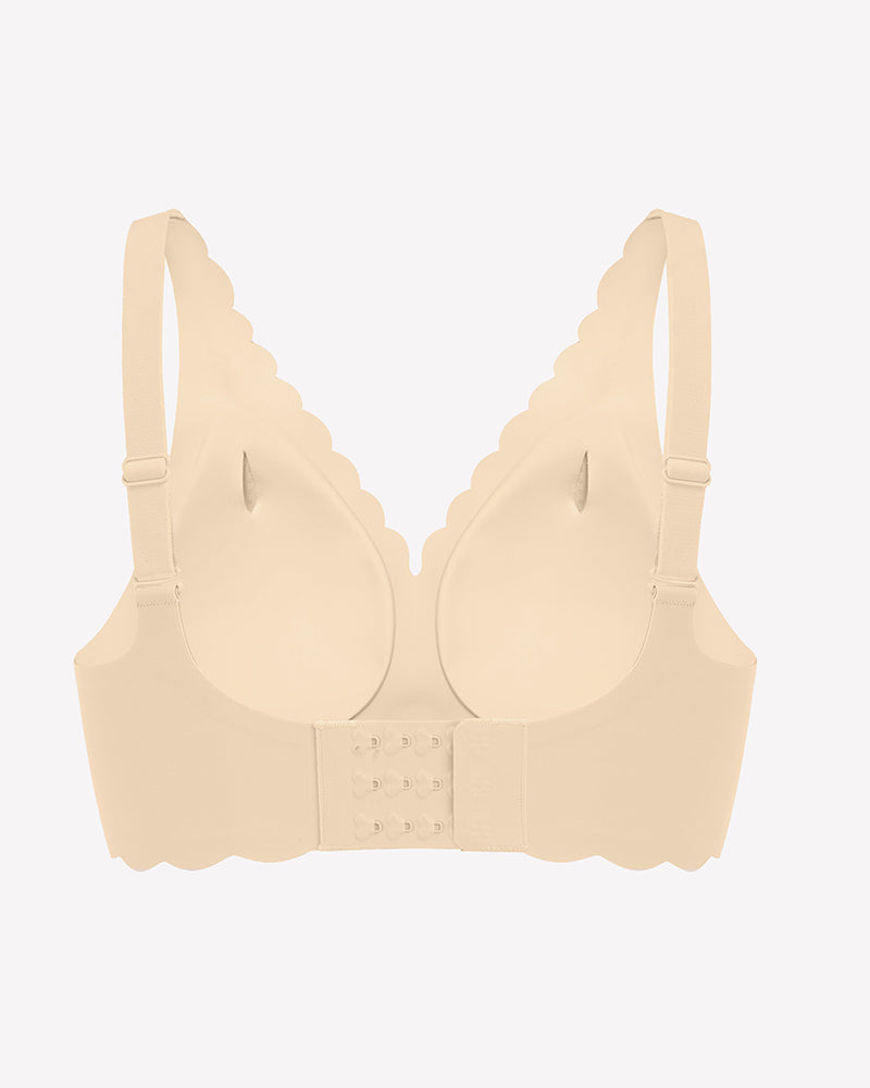 Beige seamless V-neck bra with scalloped edges, full coverage, adjustable straps, and smooth fabric.