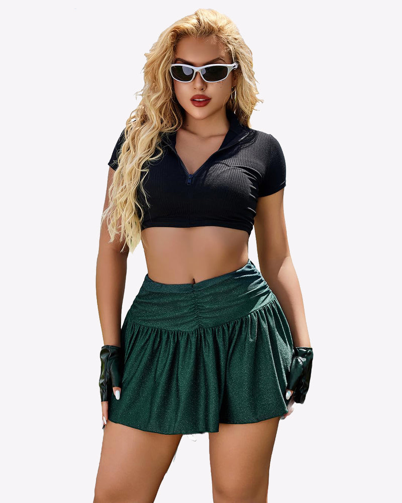 Green glitter A-line mini skirt with ruffle hem, paired with black crop top, confident look.