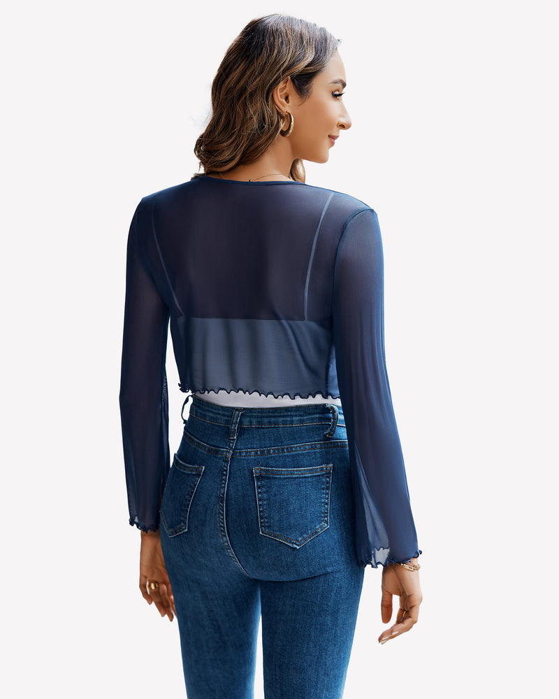 Navy blue sheer mesh shrug top with bell sleeves and tie front, paired with jeans
