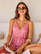 Pink heart-print romper with lace-trim V-neck, thin straps and elastic waist.