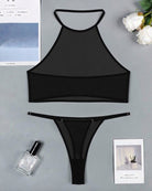 Black sheer mesh halter crop top and thong set laid flat