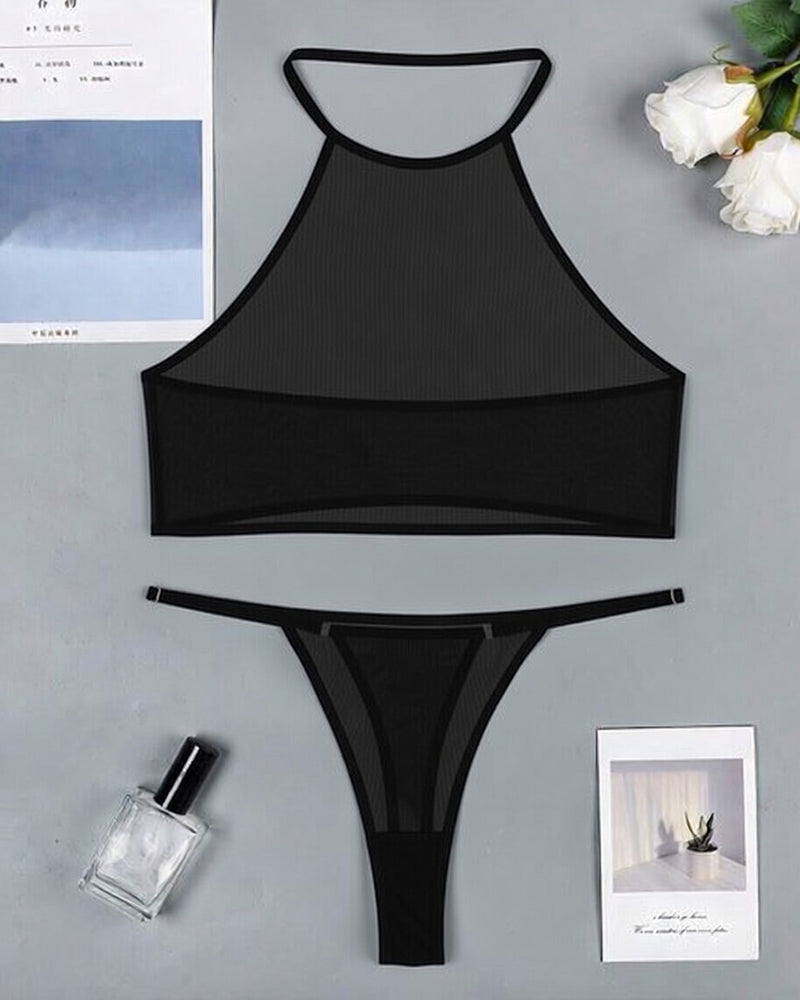 Black sheer mesh halter crop top and thong set laid flat