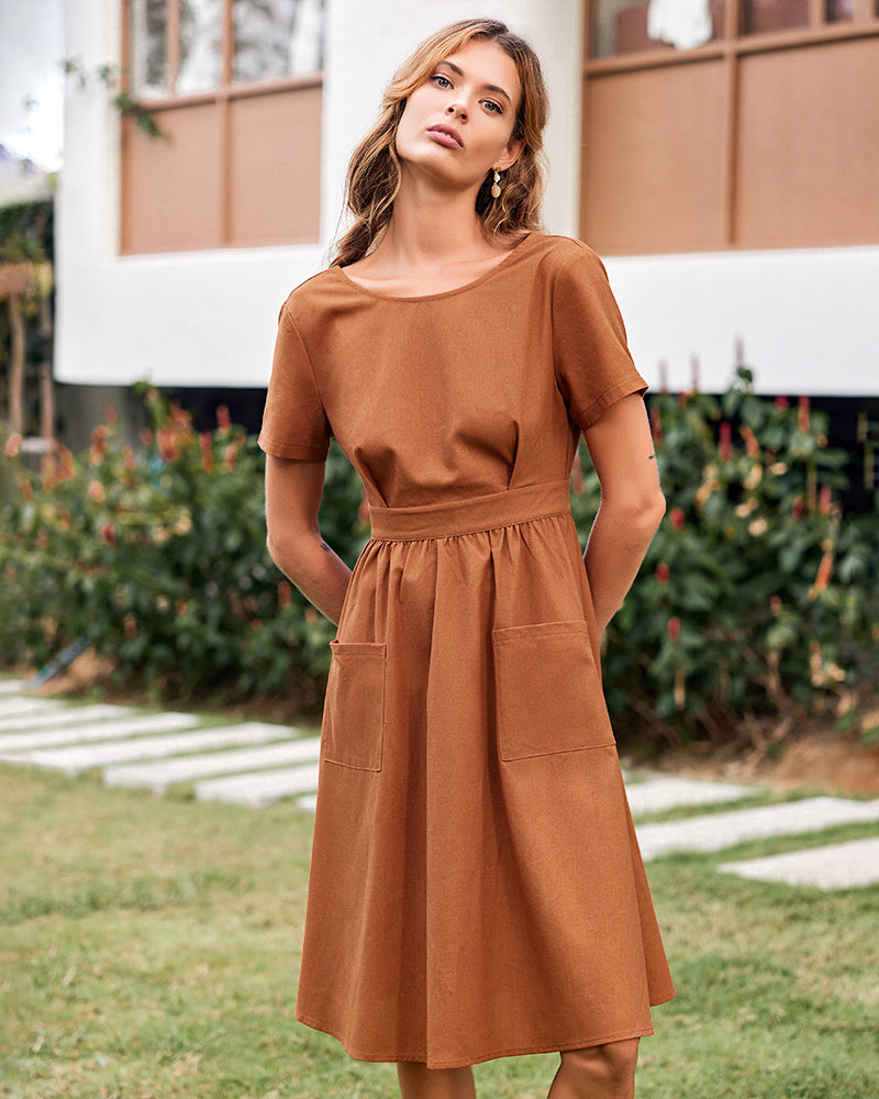 Brown midi dress with short sleeves and pockets. Comfortable open back button midi dress.