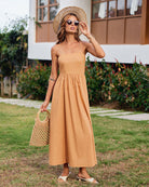 Orange cotton slip dress. Model wearing straw hat and sunglasses, perfect for summer.