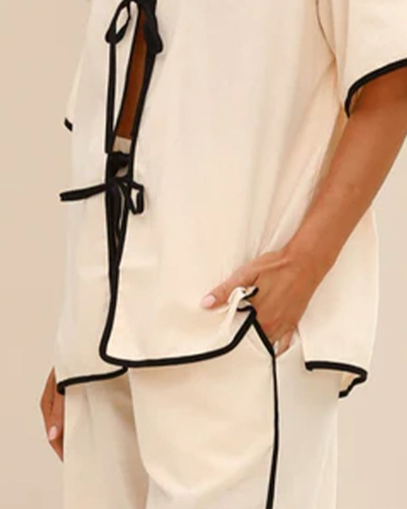 Cream linen lace-up pajama set with black trim, perfect for home wear and comfort.