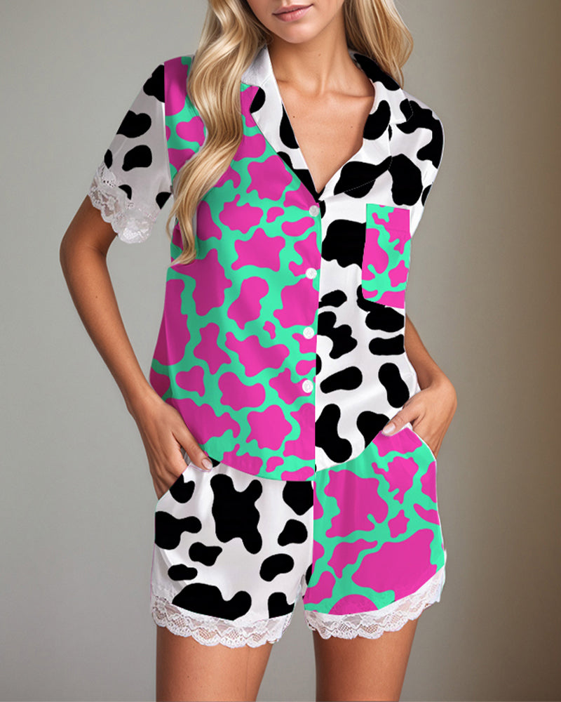 Women's satin pajama set with cow print, short sleeves, shorts, and lace trim. Silk fabric.