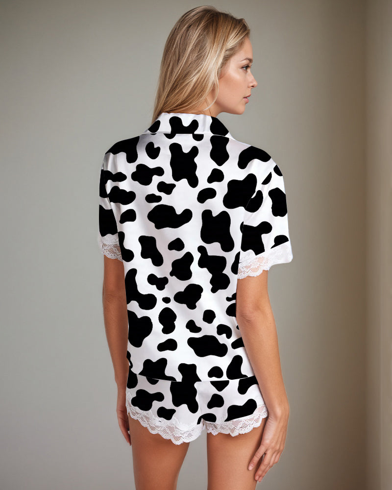 Women's cow print satin pajama set with lace trim. Comfortable silk short-sleeved shirt and shorts.
