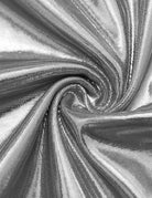 Silver metallic foil fabric close-up with shiny textured swirl pattern
