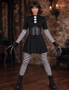 Black gothic mini dress with corset bodice, striped tights, and lace-up boots