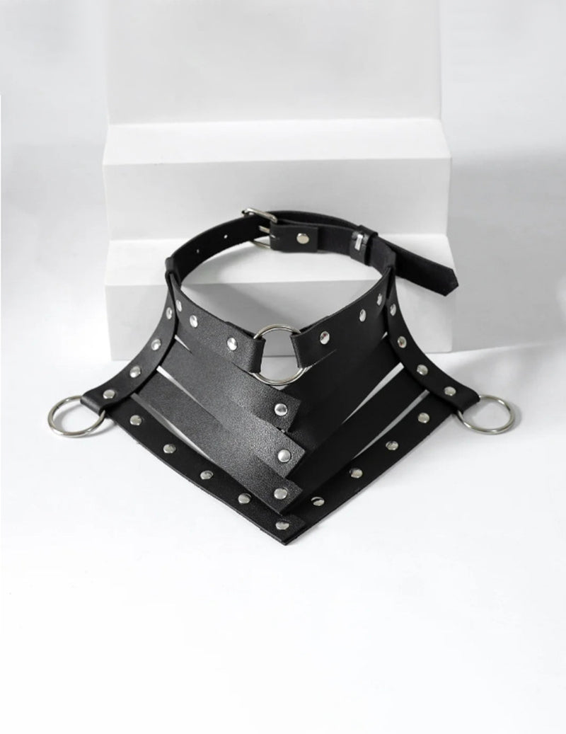 Black PU leather choker with silver studs, central D-ring, and chest strap panels